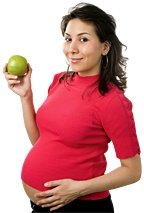 Pregnant woman holding an apple.