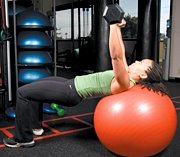 Chelsea Cooper performing stability ball barbell press.