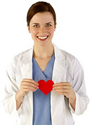 Woman in scrubs holding a paper heart.