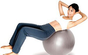 Woman does situps on excercise ball.