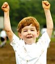 Boy raising his arms in triumph.