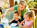 Mother and two children enjoy a meal.