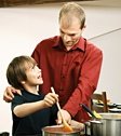 Father and son cooking together.