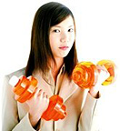 A young woman holding dumbbell weights.