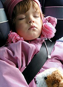 Child sitting in a car seat.