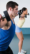 Man and woman exercising with barbells.