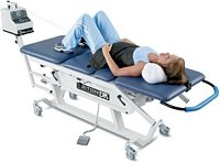 Woman on decompression table receiving therapy.