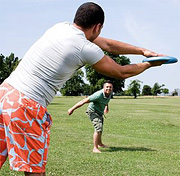 Two men playing frizbee.