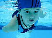 Young girl swimming underwater.