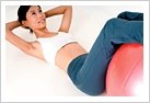 Woman doing crunchies while using exersize ball.