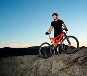 Athlete standing with mountain bike.