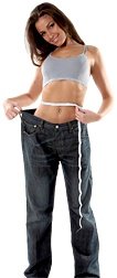 Woman wearing overly large pants to illustrate how much weight she has lost.
